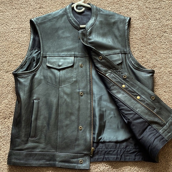 Black leather vest size XL.